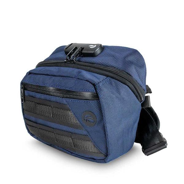 The Skunk Kross Stash Storage Bag is a small blue shoulder bag with black accents, front pockets, an adjustable strap, and a combo lock. Its carbon-lined airtight design eliminates odor and stink. Displayed against a white background.